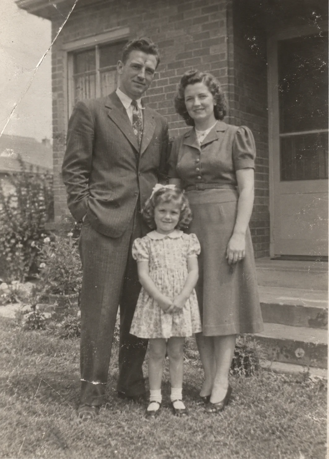 Damaged black-and-white family photograph from the 1940s